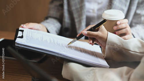 Professional business people discussing or reviewing financial report at office table