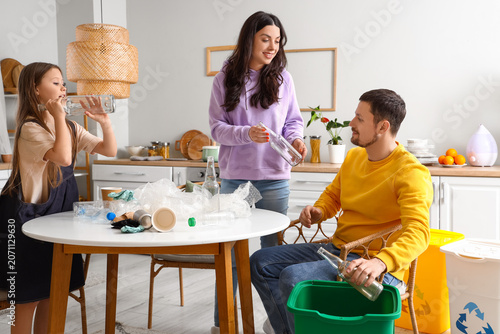 Family sorting garbage with...