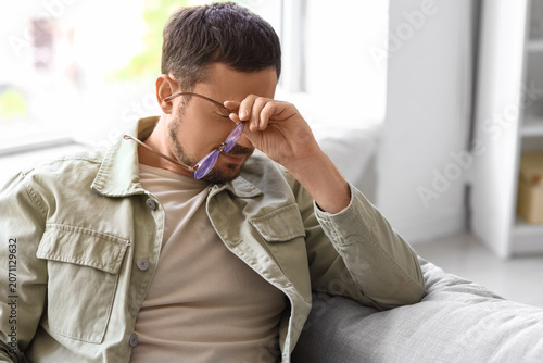 Tired young man with eyegla...