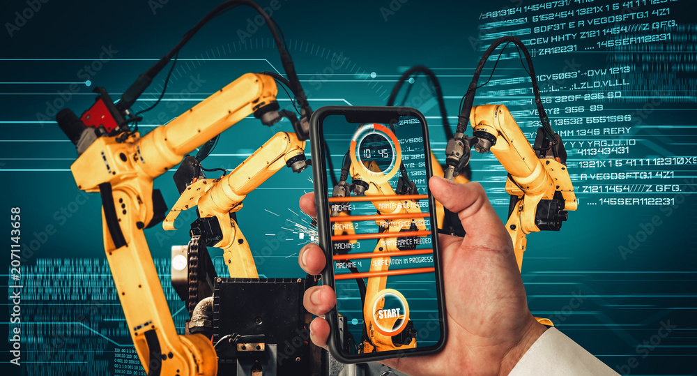 Obraz premium Engineer controls robotic arms by augmented reality industry technology application software. Smart robot machine in future factory working in concept of Industry 4.0 or 4th industrial revolution.