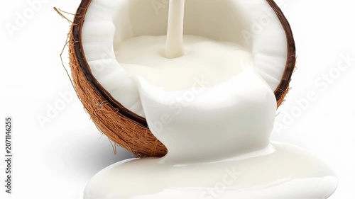 Fresh Organic Coconut Milk Pouring Over Half a Mature Brown Nut Isolated on White Background