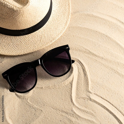 Trendy summer fashion layout featuring a pair of dark stylish sunglasses