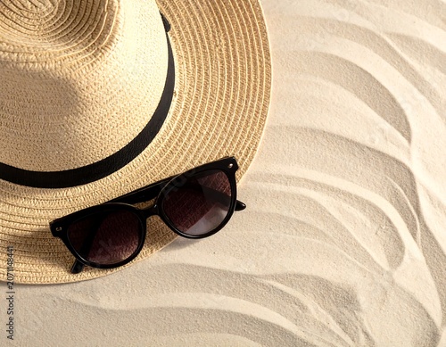 Trendy summer fashion layout featuring a pair of dark stylish sunglasses