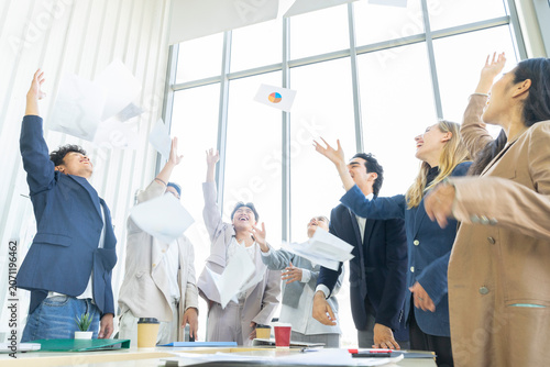 Group of diverse business people celebrating success with raised hands in the office