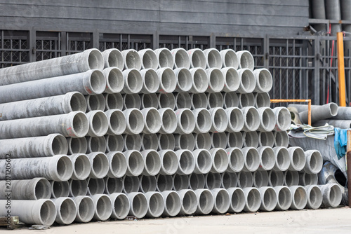 Quadro em tela Stack of heavy concrete pipes at work site
