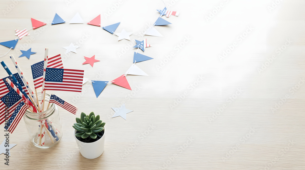 Obraz premium Festive American flags and decorations arranged on a wooden surface, perfect for celebrating holidays and events with patriotic flair