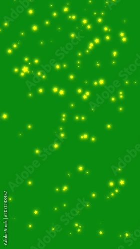 Shining Golden Stars Falling Down on Green Screen.  beautiful animation of glowing yellow and golden star particles falling vertically against a green screen backdrop