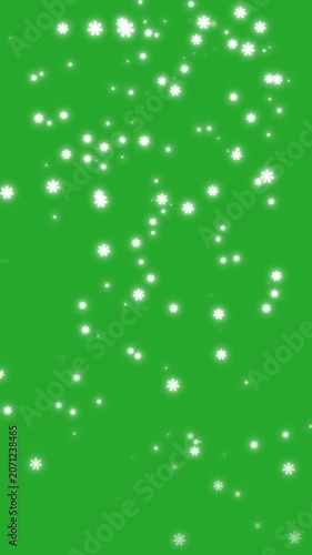 Beautiful White Snowflakes Falling on Green Screen Background. A realistic animation of white winter snowflakes gently falling against a solid green screen backdrop for keying