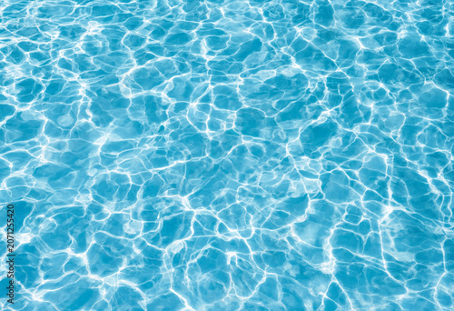 Shimmering blue water surface with sunlight reflections and ripples swimming pool light blue crystal clear sunny day reflection sunlight background transparent glistening vacation abstract