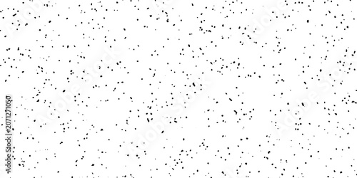Tableau sur toile A background composed of numerous small black dots scattered across a white surface, creating a textured, abstract pattern