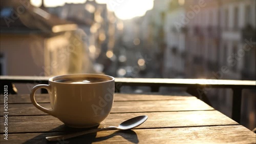 Coffee Cup On Balcony With Urban Morning Bokeh