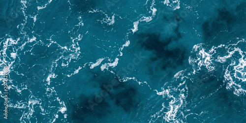 Cuadro en lienzo An abstract aerial view of swirling deep blue ocean water with white foam patterns, evoking a sense of vastness and natural energy