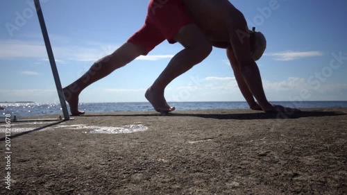 Borgholm, Sweden A man does callisthenics on a pier on the Baltic Sea. 