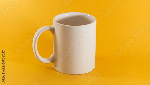 Quadro su tela Simple white mug sits alone on vibrant yellow surface