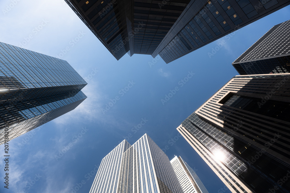 Naklejka premium Toronto, Canada - May 26, 2026: Modern Skyscrapers Viewed From Below Against Blue Sky