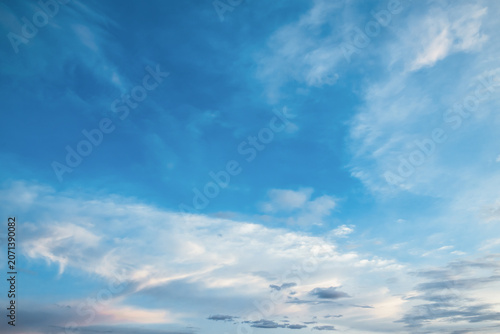 the sky is clear blue with fluffy white clouds, the sky is very bright, and the sun shines.