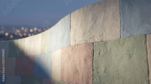 Colorful Stone Wall with City Lights Background