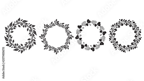 Decorative circular floral wreaths with green leaves and berries arrangement.