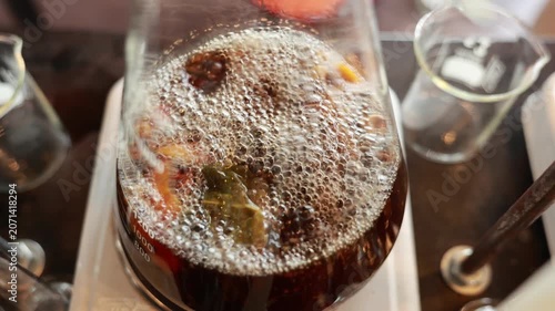 Boiling Liquid Glass Flask Distillation Process with Clear Beaker Laboratory Equipment Brown Color Science Experiment Chemical Reaction Bubbles Transparent Container Heated Surface Energetic Process