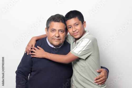 Latino single dad and his 12-year-old Latino son show their love to celebrate Father's Day