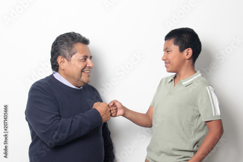 Latino single dad and his 12-year-old Latino son show their love to celebrate Father's Day