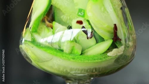Fresh cucumber green zucchini star anise almond slice clear glass vibrant refreshing perfect for gin distillation alcohol cocktail garnish close up natural light cucumber lime herb slices healthy