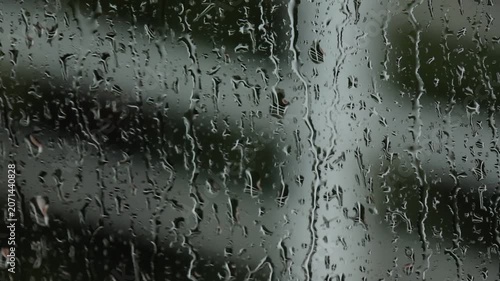 Rain water drop window glass wet blurred reflection nature weather moody storm rainy transparent surface outdoor abstract background overcast dark liquid texture peaceful contemplative mood