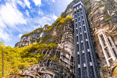 The 360-degree rotating glass elevator leads you down a nature trail through the park to the Three Natural Bridges viewpoint in the Wulong Kart Mountains, located in Chongqing, China.
