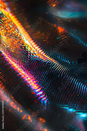 Extreme Close-Up Holographic Woven Smart Textile Fabric with Iridescent Orange and goldish reflection
