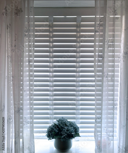 White Window Blinds with Floral Arrangement and Soft Natural Light