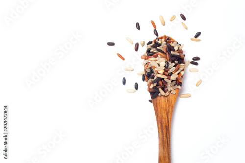 Seven different organic rice grains in a wooden spoon on white backgroiund, Healthy food concept