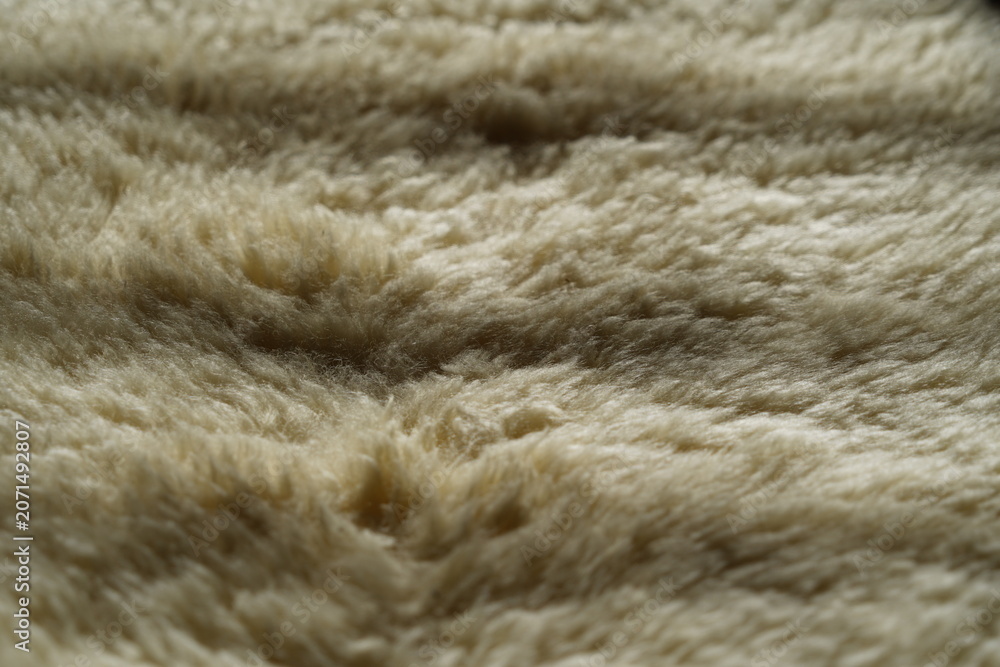 Fototapeta premium The texture of a warm fluffy sheepskin blanket
