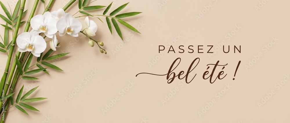 Fototapeta premium French summer greeting card orchid bamboo on elegant beige background with calligraphy text Passez un bel ete. Minimalist spa and wellness concept banner with copy space for seasonal holiday wishes.