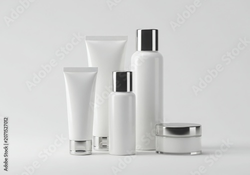 Minimalist white skincare packaging with silver accents on a white background