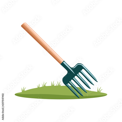 Garden fork with wooden handle on grass