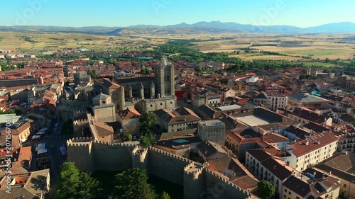 Aerial drone showcases the full extent of medieval defensive walls cathedral and historic cityscape of Avila Spain