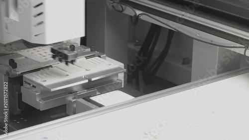 Pick and place machine assembling electronic component on production line. SMT automation in electronics manufacturing. 