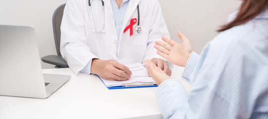 Doctor and patient having a medical consultation for red ribbon concept of December World Aids Day, MADD, October Red ribbon week, February Heart month, Marfan Syndrome, May Stroke awareness