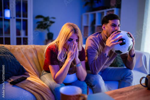 Schilderij op canvas Frustrated soccer fans feeling disappointment watching game at home