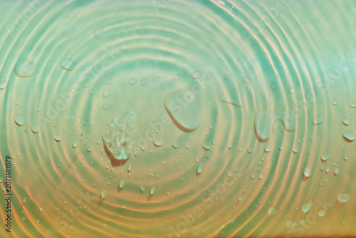 Blue water with ripples on the surface. Defocus blurred transparent blue colored clear calm water surface texture with splashes and bubbles. Water waves with shining pattern texture background.