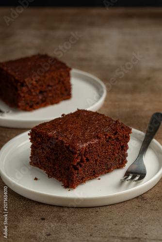 Chocolate pudding or chocolate rich cake on a brown table. Vertical image. Copy space.