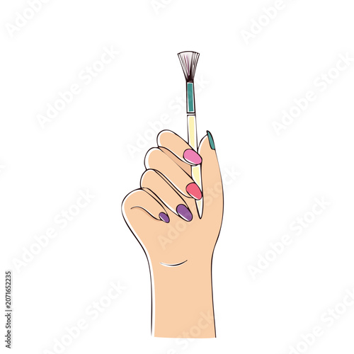 Hand holding paintbrush with colorful nail polish