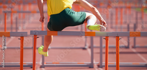 A hurdle runner leaping over the hurdles, man is jumping over the hurdle