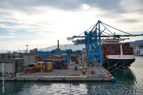 Industrial Cargo Port with Large Cranes and Shipping Containers.