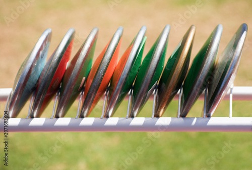 Athletics throw the discus, athletic discs in the rack
