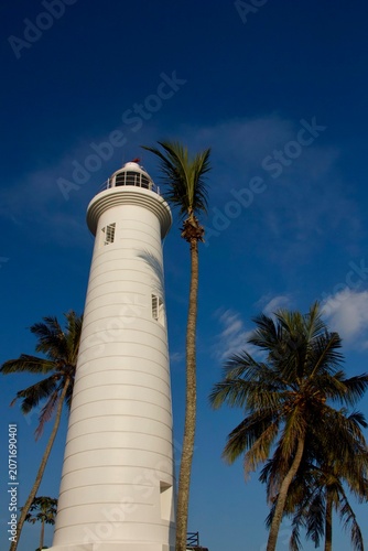 Galle Lighthouse with Palm Trees Against Blue Sky Sri Lanka