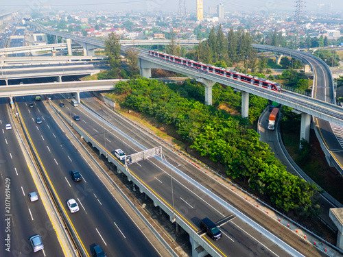 Aerial View of Modern City Highway, Flyovers, and LRT Train Infrastructure