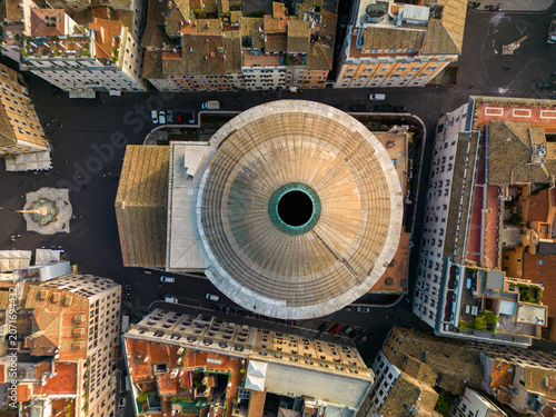 Aerial view of the Pantheon with its iconic circular dome and central oculus, surrounded by historic rooftops, narrow streets, and the city square in Rome, Lazio, Italy.
