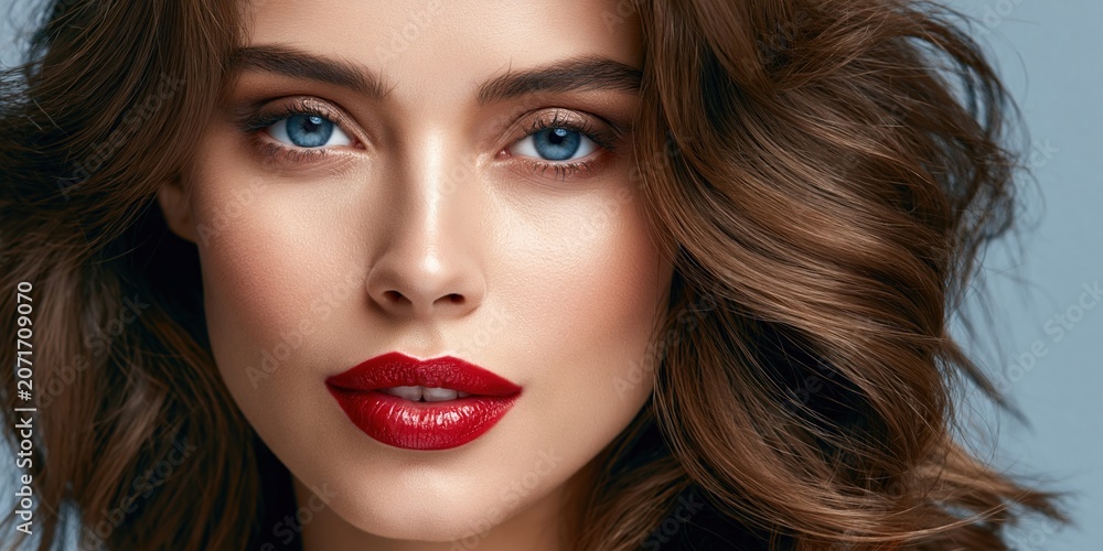 Fototapeta premium Glamorous woman with striking red lips and eye makeup