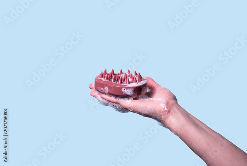 Photos Hair brush for stimulating hair growth on blue background